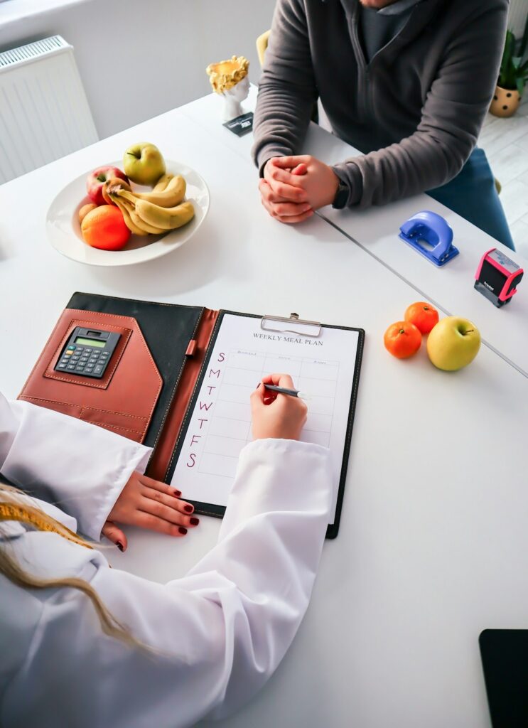 two-people-sitting-at-a-table-writing-on-a-clipboard-66eedpb6ekg